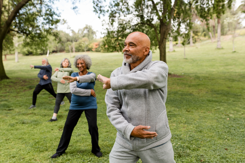 A diverse group of seniors practice martial arts in their local park.